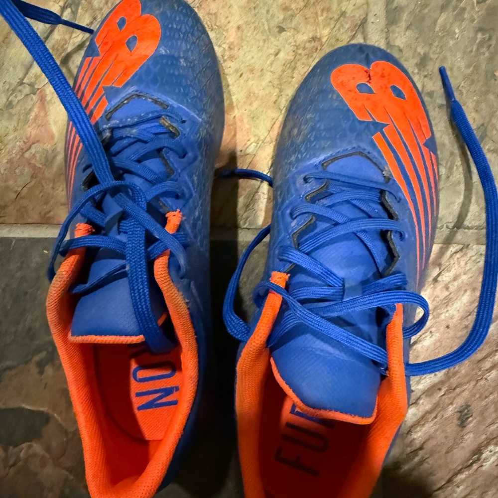 New Balance Blue and Orange Furon cleats with Bold Accents